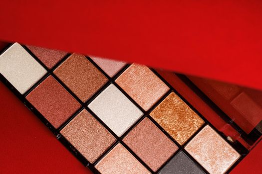 Makeup eyeshadow palette on the red background.