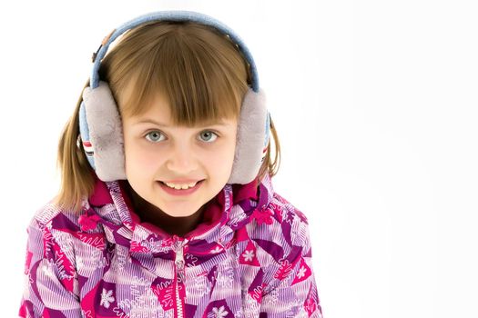 A little girl with headphones listening to music.
