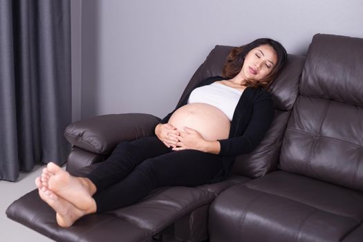 Pregnant woman sleeping on sofa