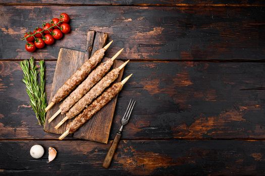 Tikka, shish and kofta kebabs, on old dark wooden table background, top view flat lay, with copy space for text