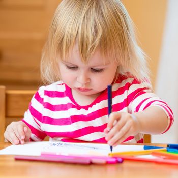 Cute little girl draws felt-tip pens