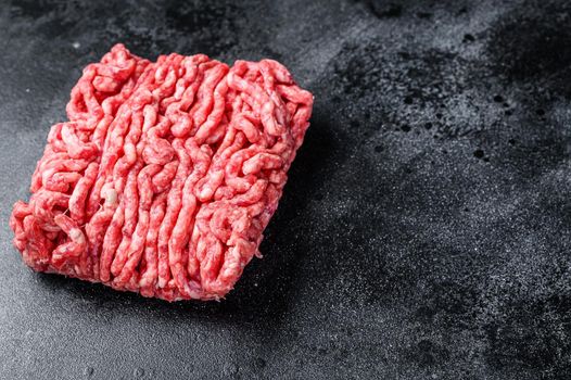 Raw mince beef, ground meat. Black background. Top view. Copy space