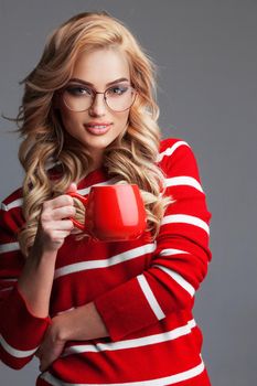 Woman in glasses holding red cup