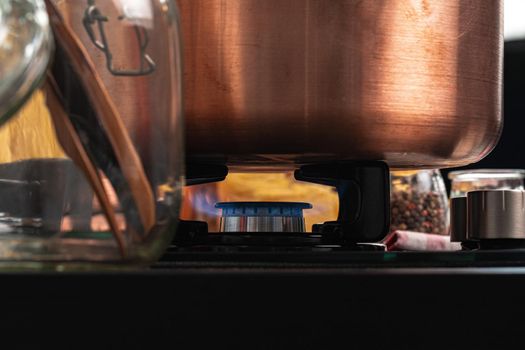 Metal pot on a gas stove burner close up