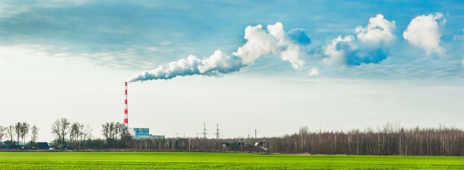 Environmental pollution, environmental problem, smoke from the chimney of an industrial plant or thermal power plant against a cloudy sky, panoramic view, high resolution