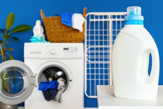 Bottle of detergent whith washing machine, indoors