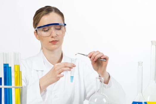Young female research scientist puts sample