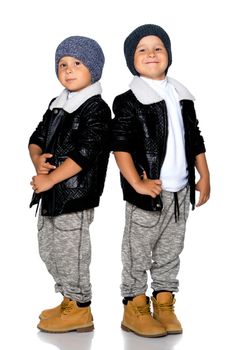 Two little boys in black jackets and hats.