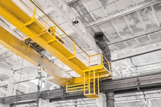 Overhead construction crane on the background of an industrial building enterprise