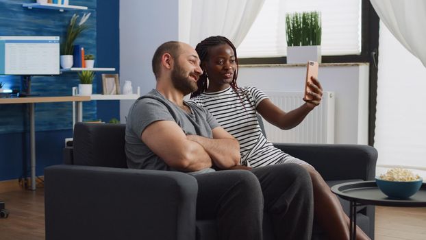 Interracial partners using video call on smartphone