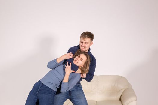 people, abuse and violence concept - agressive man strangling his wife