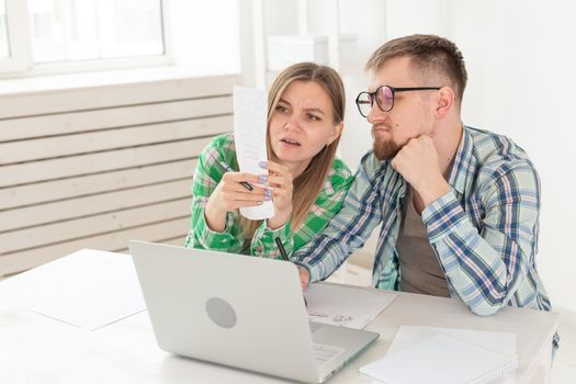 Upset husband and wife consider the total costs of payments and purchases made over the past month. The concept of low standard of living of students.
