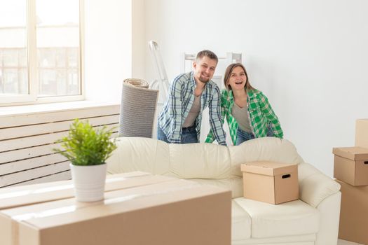 Family, new apartment and relocation concept - Young couple moving in new house