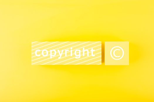 Minimal yellow copyright and intellectual property protection concept on yellow background