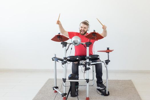 People, free time and hobby concept - Cool male drummer over white room background