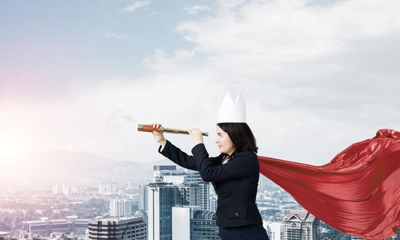 Concept of power and sucess with businesswoman superhero in big city
