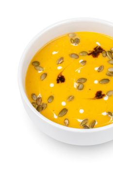 Bowl of pumpkin soup isolated on white