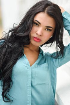 Hispanic young woman wearing casual clothes in urban background