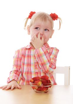little girl eats strawberries