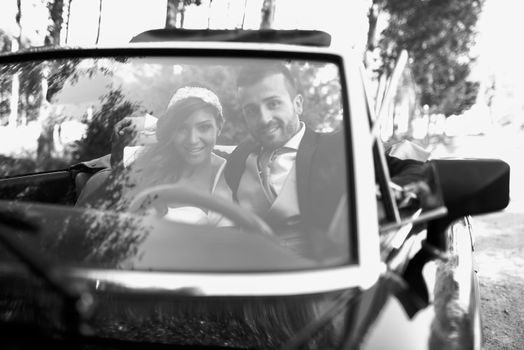 Just married couple in an old car