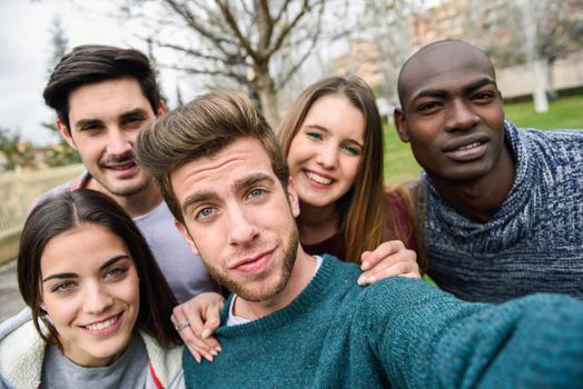 Multiracial group of friends taking selfie