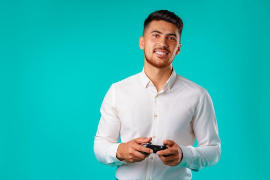Handsome mixed-race man holding video games joystick