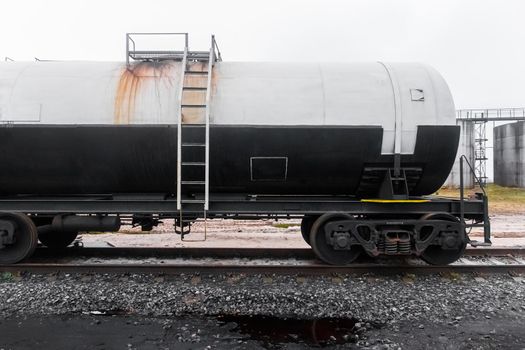 Dirty railway tank car with fertilizers or chemical products after unloading at an industrial plant