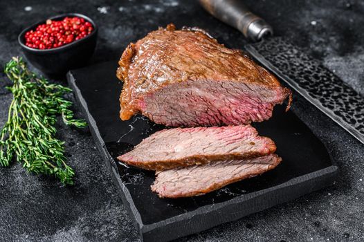Roast beef tri tip steak bbq. Black background. Top view