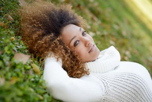 Young African American girl with afro hairstyle and green eyes