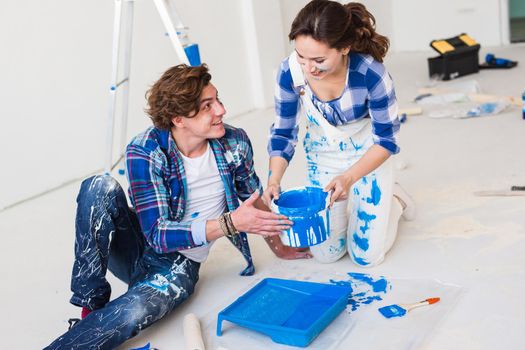 Renovation, repair and people concept - Close up portrait of couple stained with paint over white background