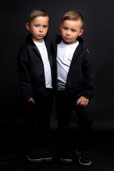 Two beautiful boys in black suits