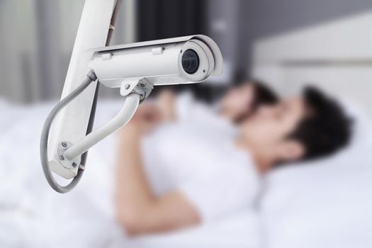 CCTV Camera surveillance operating with couple sleeping in bedroom