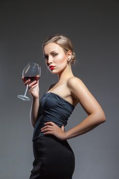 Woman in black dress with wine glass