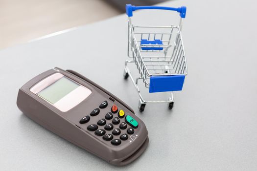 Top view photo of shopping trolley and cash register