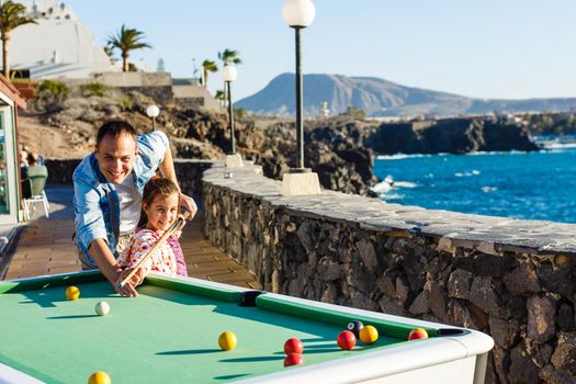 pool table near the sea, family plays billiards