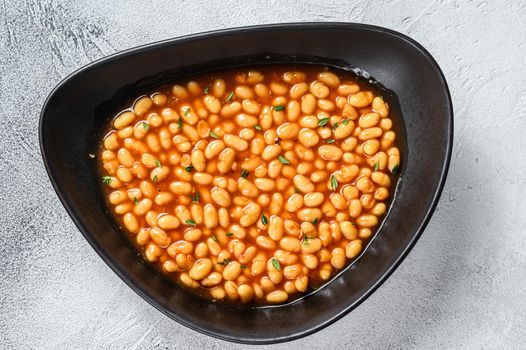 Baked beans in tomato sauce in a plate. White background. top view