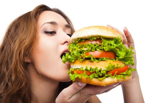 Happy Young Woman Eating big yummy Burger isolated