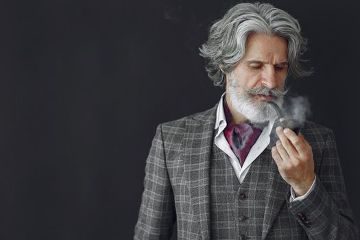 Elegant senior man with a smoking pipe