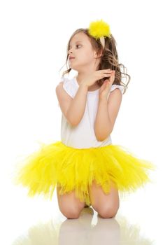 Little girl in a yellow skirt and white t-shirt.