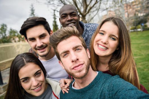 Multiracial group of friends taking selfie