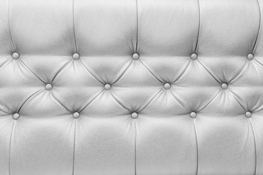 Light grey or white leather upholstery sofa with pattern button design furniture style decor texture background