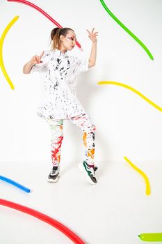 Creative woman in white clothes stained with colorful paint