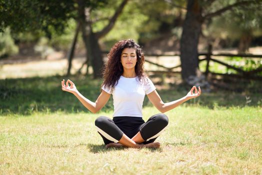 Young Arab woman doing yoga in nature