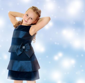 Beautiful little girl dressed in a blue dress.