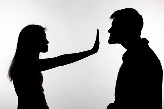Man abusing woman, silhouette on a white background. Stop sexual assault