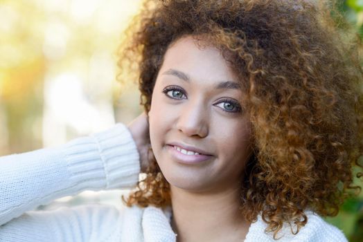 Young African American girl with afro hairstyle and green eyes
