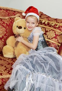 Little Princess at the new year's eve with a Teddy bear.