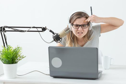 Radio host, streamer and blogger concept - Woman working as radio host at radio station sitting in front of microphone