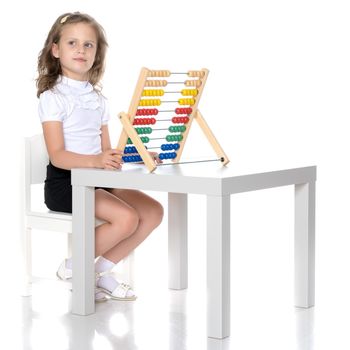 The girl counts on abacus