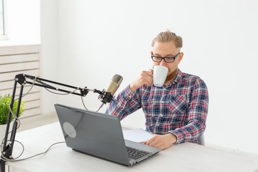 Radio host concept - Handsome man working as radio host at radio station